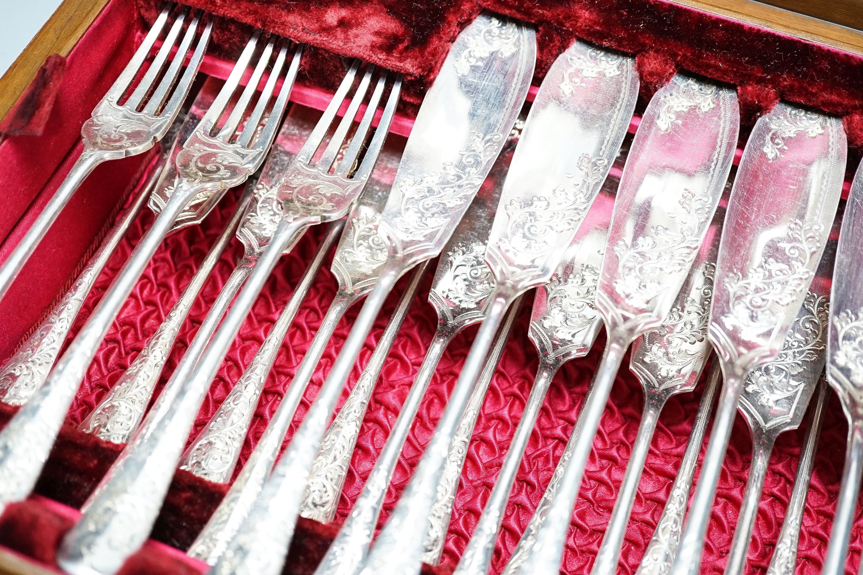 A cased set of plated engraved fish cutlery